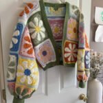 Colorful crochet cardigan with retro daisy granny square pattern