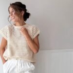 Cream open-weave rattan-style crochet top with short sleeves